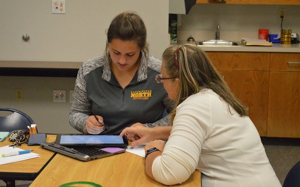 Jan Pierson, Lead Coordinator for Homework Help at Monroe County Library, helps Bailey Fries, 11th grader at Bloomington North High School with math homewok as part of the library's teen SAT prep sessions. 