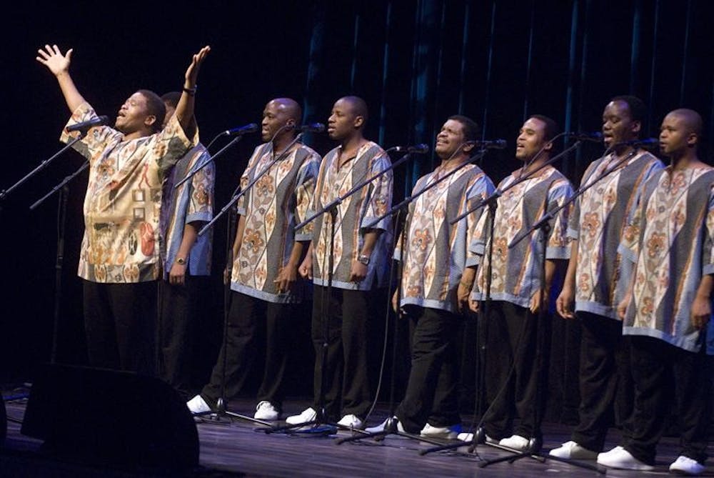 Ladysmith Black Mambazo founder Joseph Shabalala, raises his arms and sings with the South African choral group Monday evening during their performance at IU Auditorium. The Grammy award-winning group reached an international audience after recording with American folk singer Paul Simon on his album Graceland.
