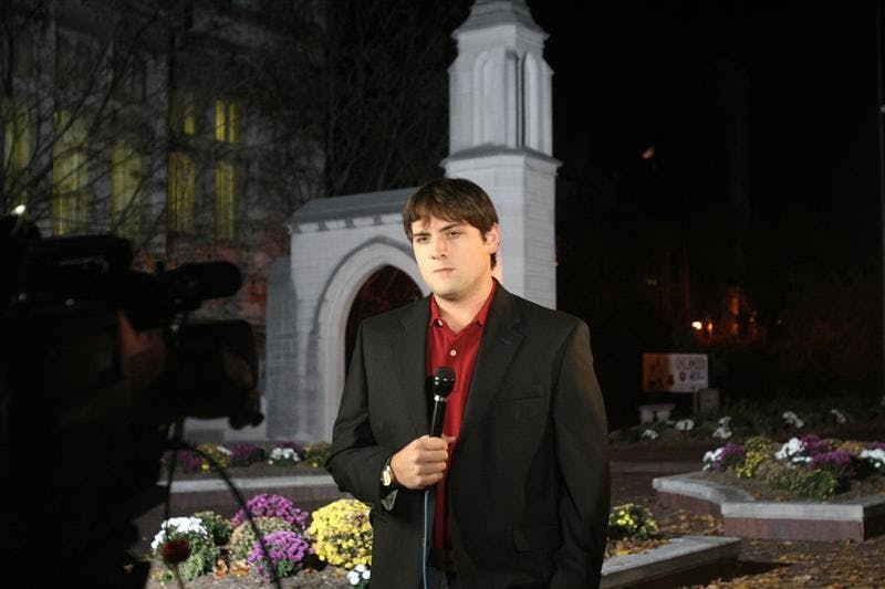 Luke Russert, NBC correspondent, prepares to do a live stand up for the "NBC Nightly News with Brian Williams" on Monday night in front of the Sample Gates. Russert will be on campus today filming live segments for NBC's "Today Show" and other election coverage.