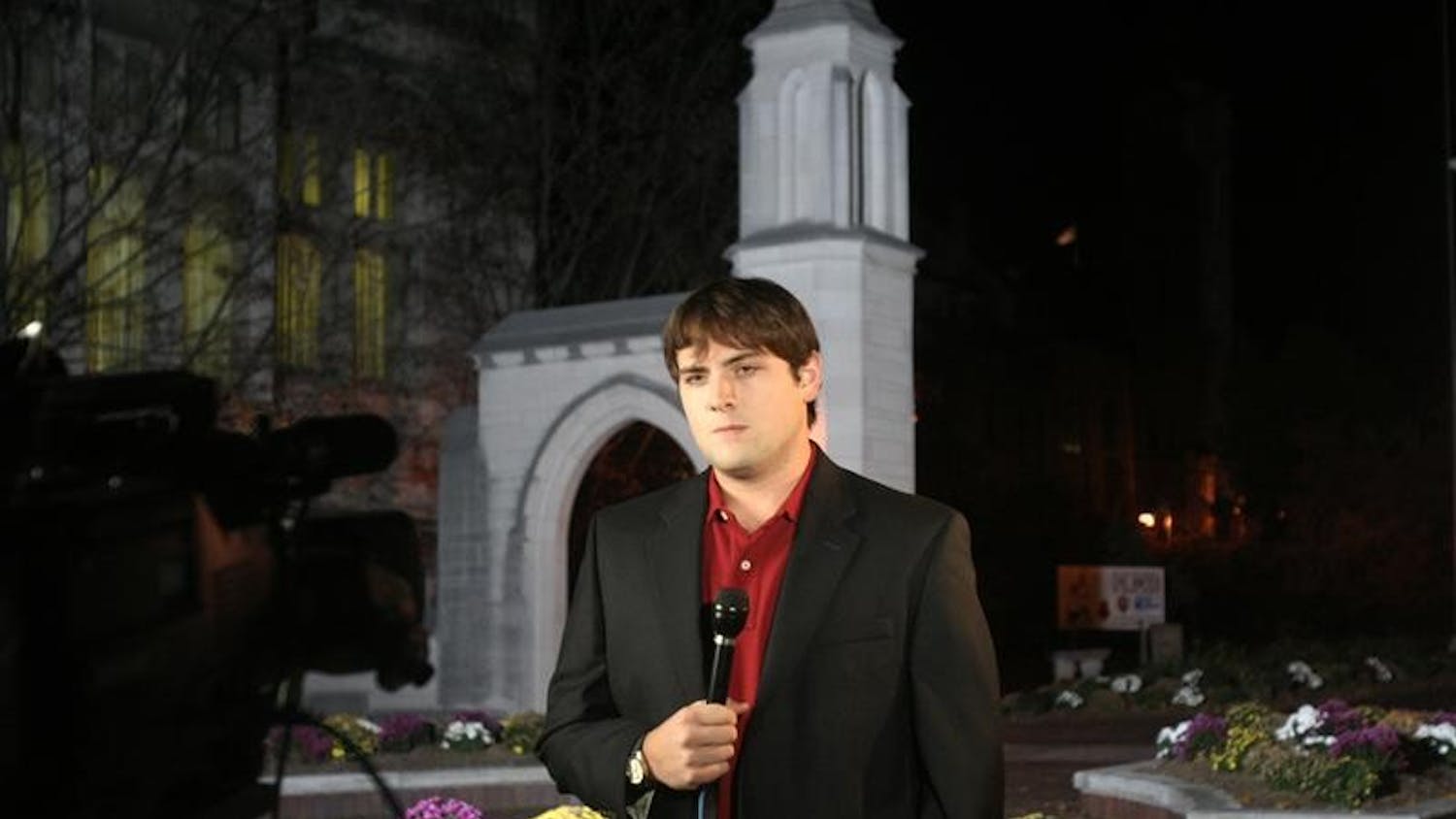 Luke Russert, NBC correspondent, prepares to do a live stand up for the "NBC Nightly News with Brian Williams" on Monday night in front of the Sample Gates. Russert will be on campus today filming live segments for NBC's "Today Show" and other election coverage.