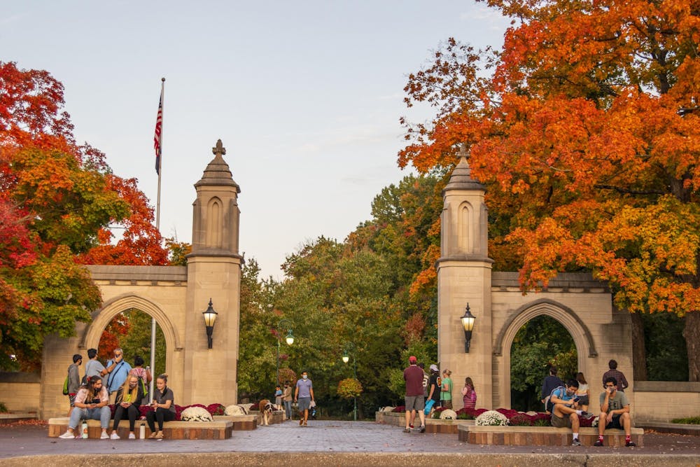 People walk and sit Oct. 10 around the Sample Gates. 