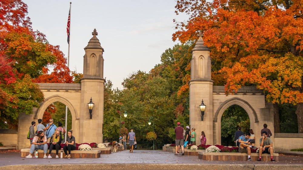 People walk and sit Oct. 10 around the Sample Gates. 