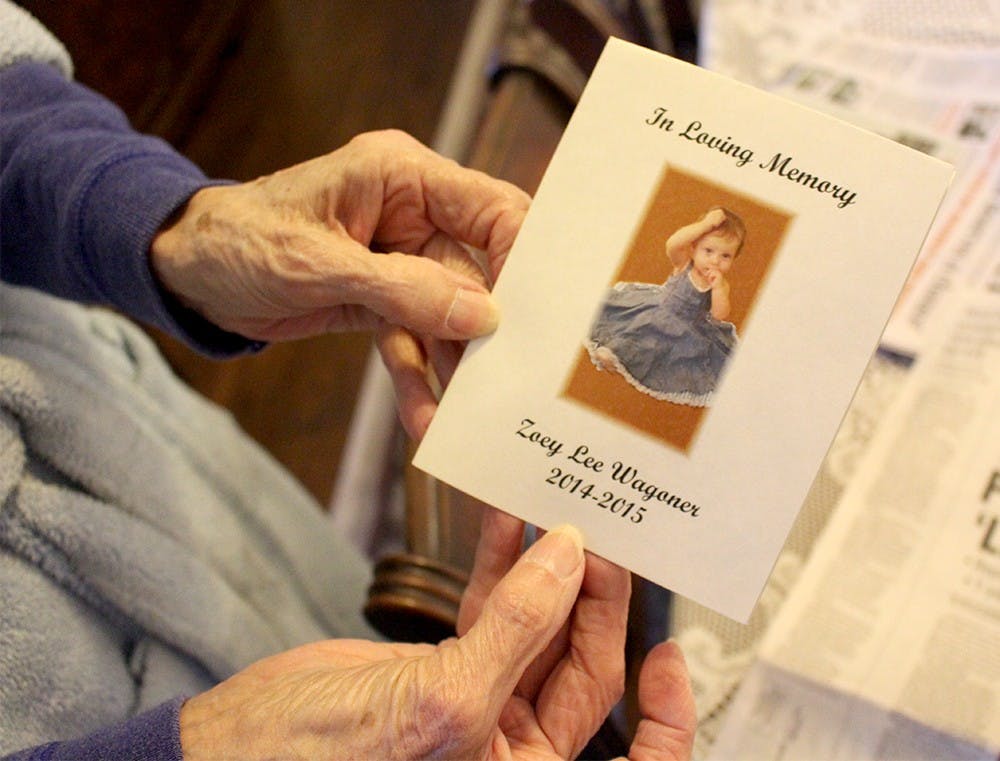 Virginia McPherson, 85, the Wagoner's neighbor, holds the invitation she received last year to the funeral of one-year-old Zoey Wagoner Wednesday at her house. On Wednesday, the day of Matthew S. Wagoner's sentencing, she stayed inside her home in Greenfield with her dog Susie. Last May, on the day before Zoey was killed, she was sitting on her front porch with Susie when she saw Jessica Wagoner walking by in a stroller. Virginia went up and touched Zoey's hand and smiled at the infant. "I'll never forget the look on that child's face," she said. 