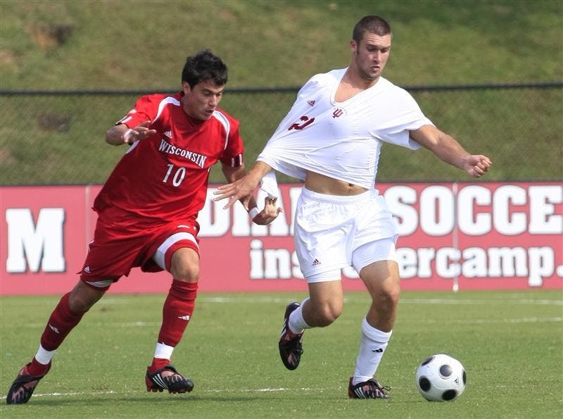 Freshman forward Will Bruin struggles to keep control of the ball as Winsconsin's Pablo Delgado Inglada grabs his shirt during Sunday's game at Bill Armstrong Stadium.