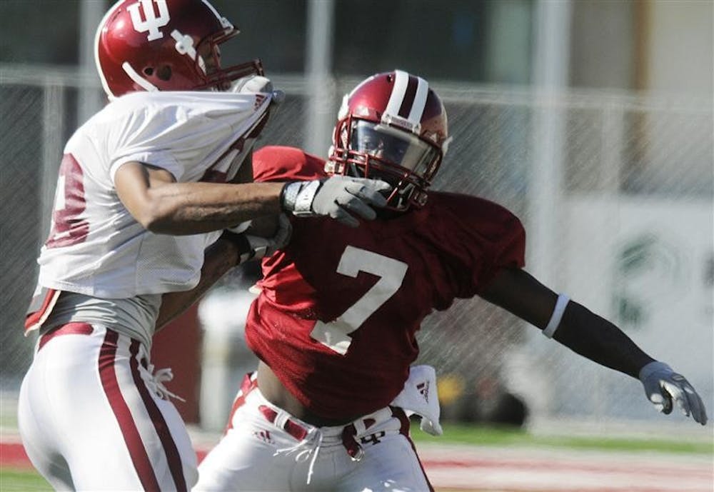 IU senior cornerback Ray Fisher, right, gets physical with wide receiver teammate Damarlo Belcher during practice Thursday at Memorial Stadium. Fisher was a wide receiver last season, but made the jump to the defensive unit this season.