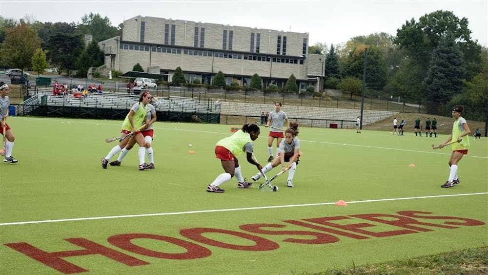 The field hockey team warms up before their game against Ohio on Saturday at the IU Field Hockey Field.