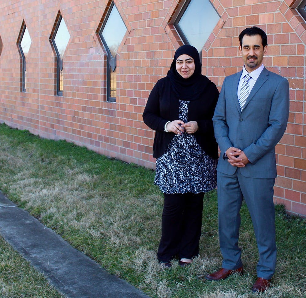 Faryal Khatri and Hazem Bata stand in front of the wall that was marred by anti Muslim graffiti over the weekend. A volunteer from the community scrubbed the wall clean the day of the incident. 