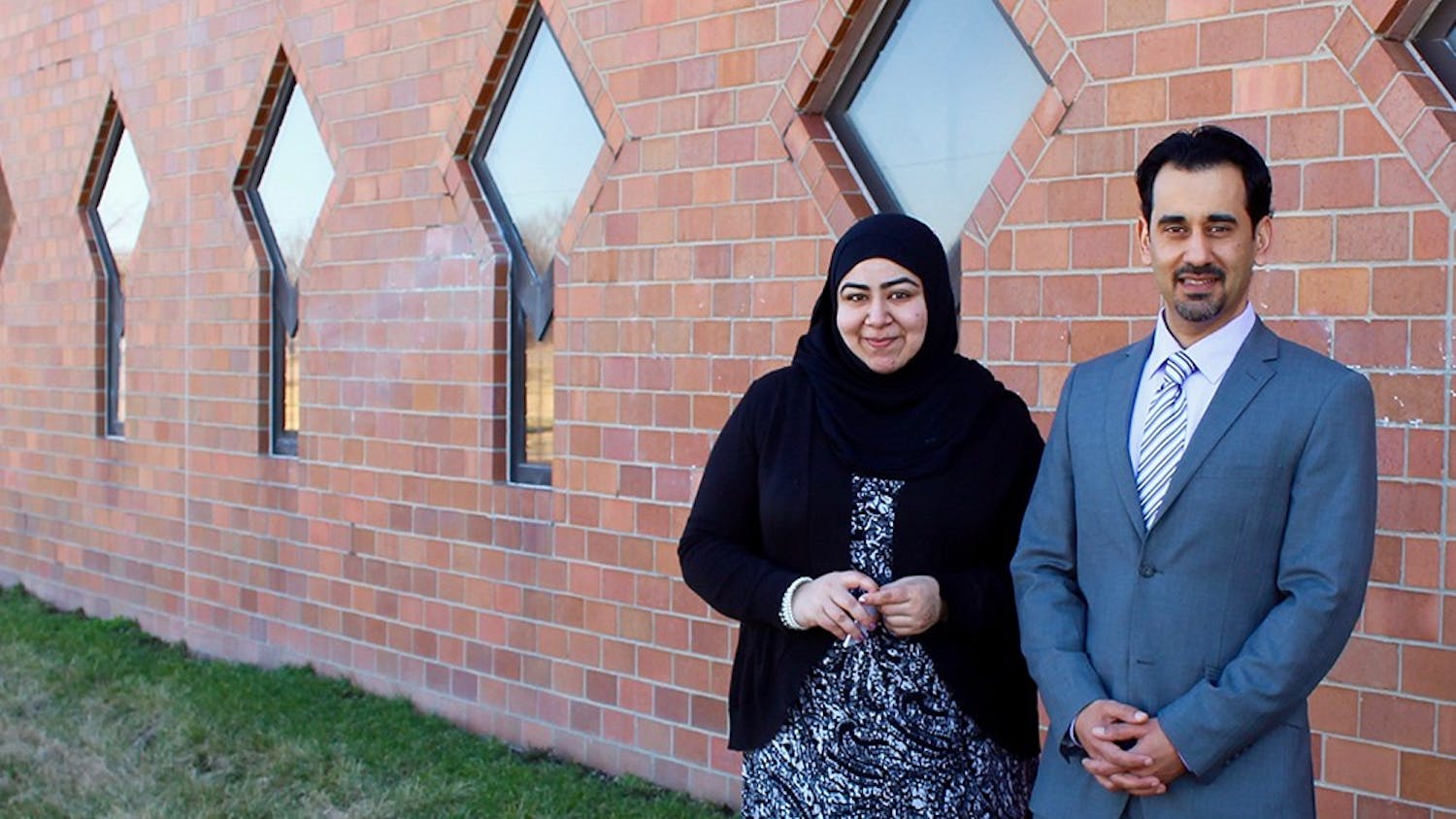 Faryal Khatri and Hazem Bata stand in front of the wall that was marred by anti Muslim graffiti over the weekend. A volunteer from the community scrubbed the wall clean the day of the incident.