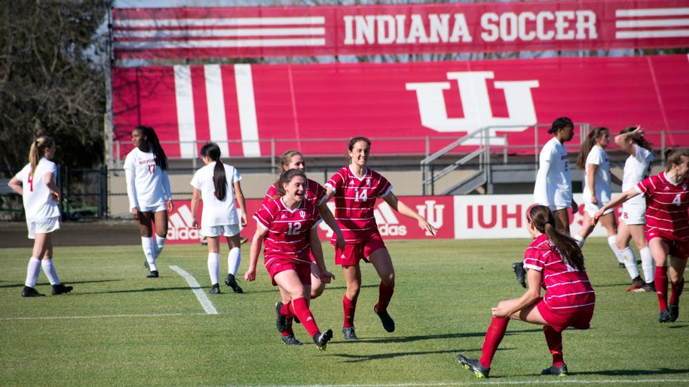 Players on the IU women's soccer team celebrate Feb. 25 during the game against Rutgers. IU tied Purdue 0-0 Saturday night in West Lafayette, Indiana.