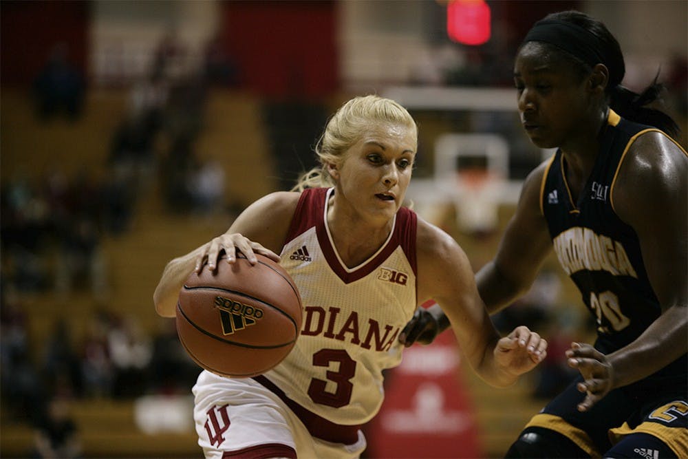 Sophomore guard Tyra Buss dribbles the ball around a Chattanooga defender. Buss led the Hoosiers in scoring with 16 points to help IU beat Chattanooga 54-43