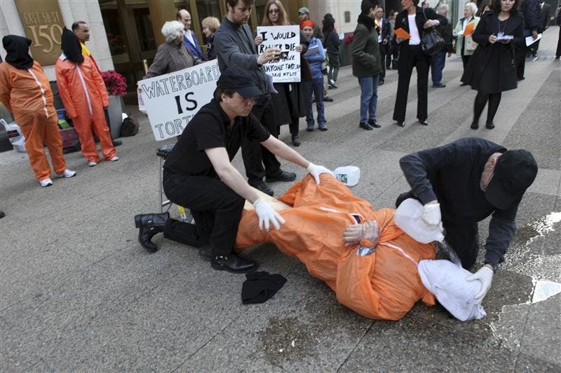 Mike Morice, center, and other members of World Can't Wait group perform a live waterboarding demonstration outside the Spanish Consulate in Manhattan to urge prosecution in Spain of the alleged involvement of Bush administration officials in the torture of terror suspects, Thursday in New York.  