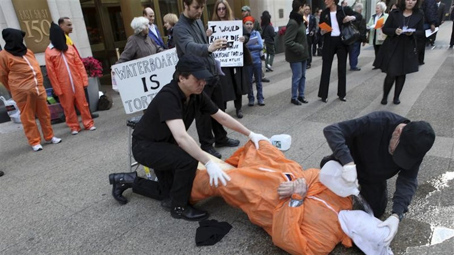 Mike Morice, center, and other members of World Can't Wait group perform a live waterboarding demonstration outside the Spanish Consulate in Manhattan to urge prosecution in Spain of the alleged involvement of Bush administration officials in the torture of terror suspects, Thursday in New York.