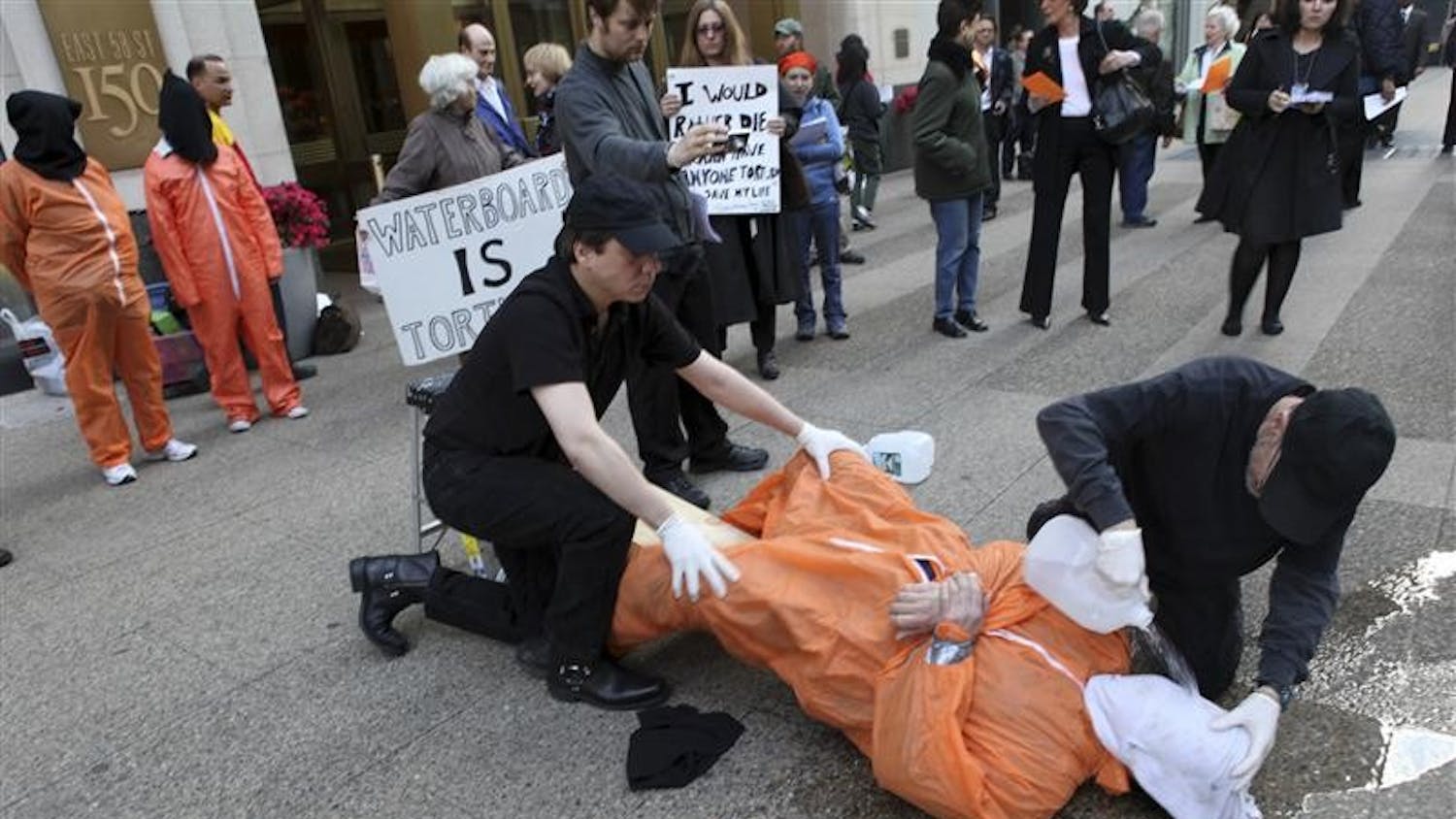 Mike Morice, center, and other members of World Can't Wait group perform a live waterboarding demonstration outside the Spanish Consulate in Manhattan to urge prosecution in Spain of the alleged involvement of Bush administration officials in the torture of terror suspects, Thursday in New York.  