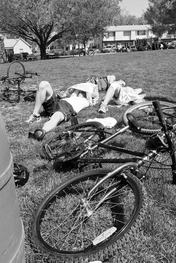 Jacob Wick, Joey Tharp, and Jim Wollenburg of team Triple Threat rest Saturday while waiting for other teams to finish the second annual Hoosier Hustle at Third Street Park. Team Triple Threat was the first team back to the park at the end of the race.