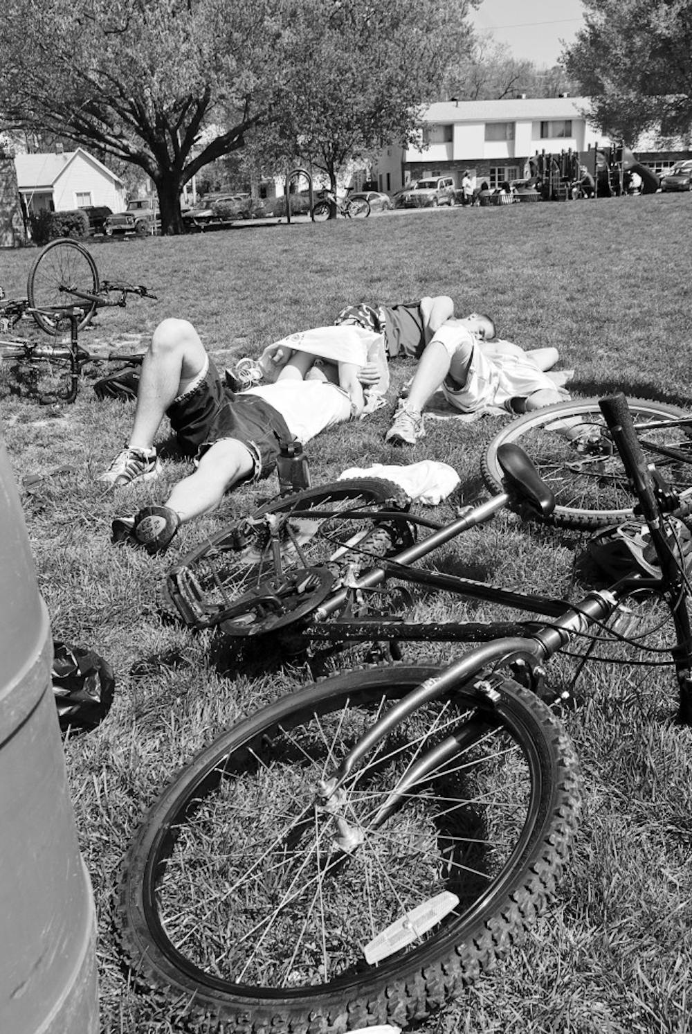 Jacob Wick, Joey Tharp, and Jim Wollenburg of team Triple Threat rest Saturday while waiting for other teams to finish the second annual Hoosier Hustle at Third Street Park. Team Triple Threat was the first team back to the park at the end of the race.