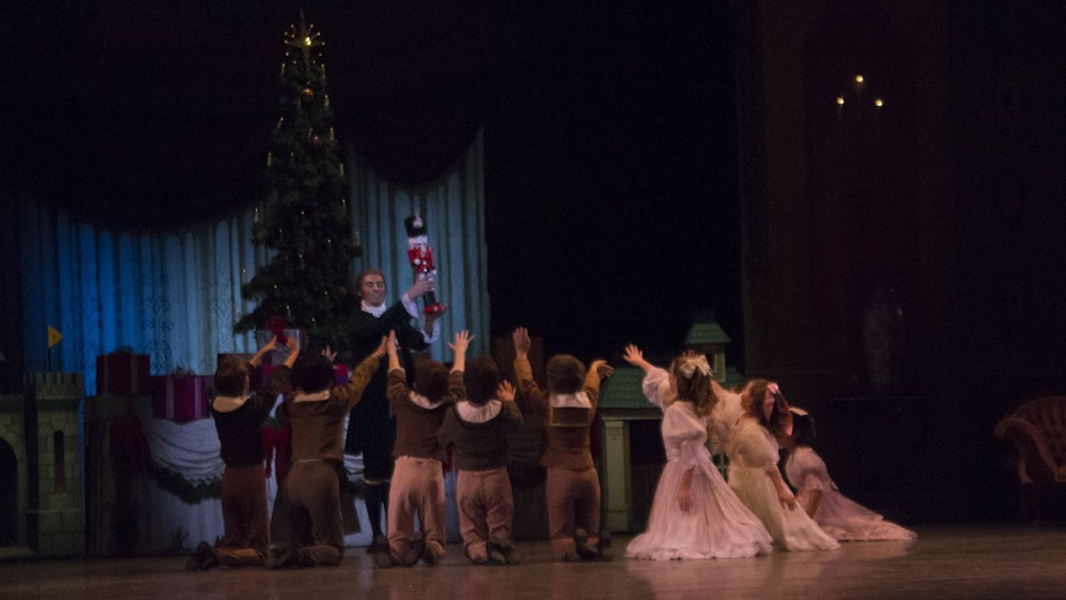 Drosselmeyer, played by junior Antonio Houck, shows a nutcracker to the children in "The Nutcracker". The ballet will run Nov. 30, Dec. 1 and 2 at 7:30 p.m., and Dec. 2 and 3 at 2 p.m. at the Musical Arts Center.