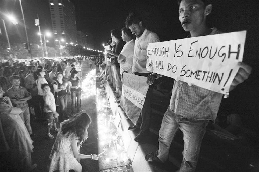 Residents of Mumbai hold a candlelight ceremony and a protest on Sunday after attacks on the city killed at least 174 people. The death toll was revised down Sunday from 195 after authorities said some bodies were counted twice, but they said it could rise again as areas of the Taj Mahal were still being searched. Among the dead were 18 foreigners, including six Americans. Nine gunmen were killed.