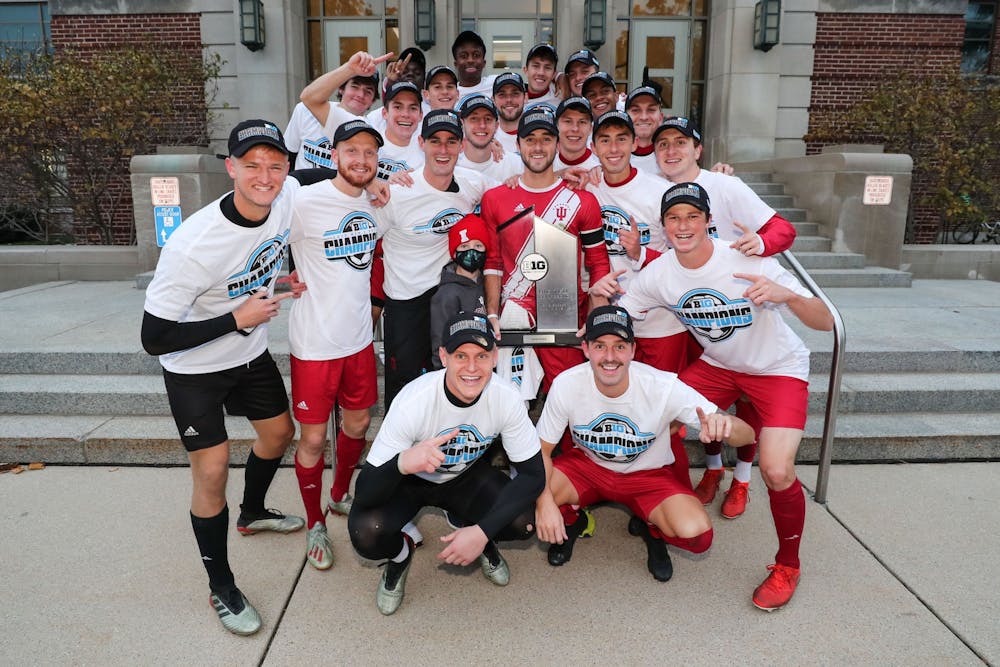 The IU men&#x27;s soccer team poses with the Big Ten regular season trophy after defeating Michigan State on Nov. 3 in East Lansing, Michigan.