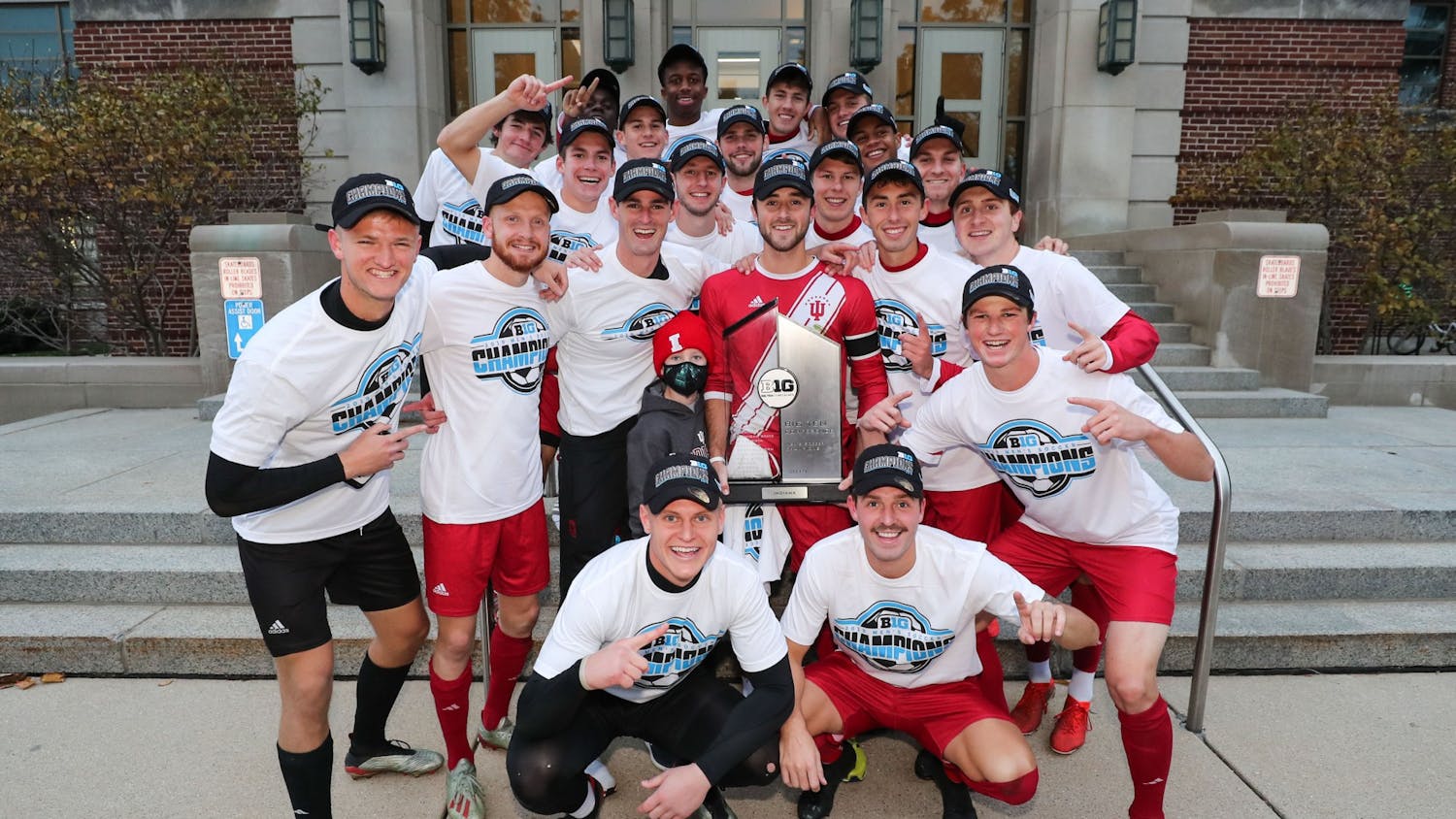 The IU men&#x27;s soccer team poses with the Big Ten regular season trophy after defeating Michigan State on Nov. 3 in East Lansing, Michigan.