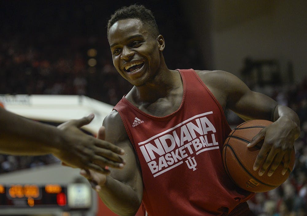 Junior Kevin "Yogi" Ferrell high-fives junior Hanner Mosquera-Perea before the dunk contest Saturday during Hoosier Hysteria at Assembly Hall.