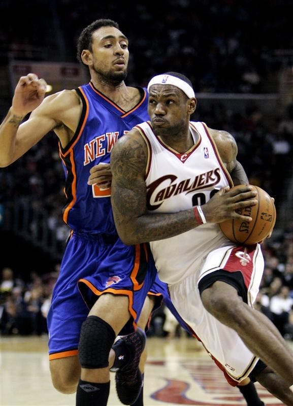 Cleveland Cavaliers' LeBron James, right, drives to the basket past New York Knicks' Jared Jeffries in the third quarter Sunday in Cleveland. James scored 19 points and added 10 assists to the Cavaliers' 98-93 win. (AP Photo/Mark Duncan)