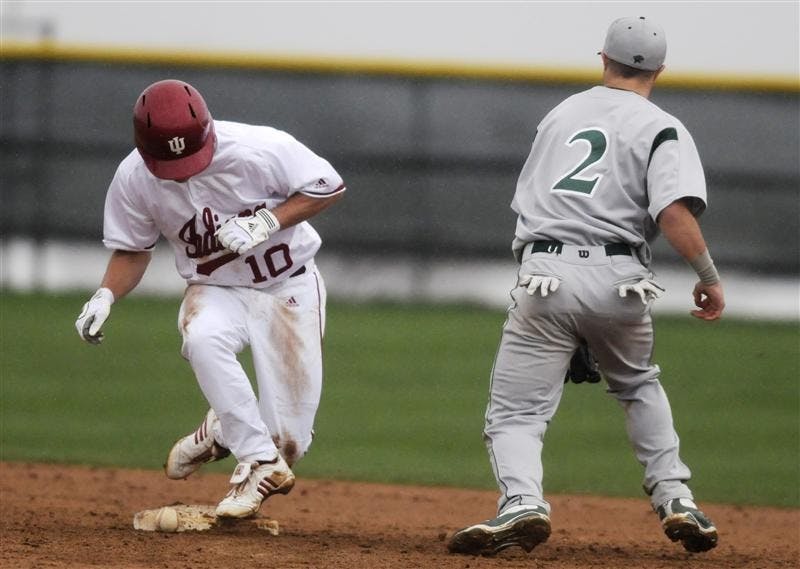 Sophomore outfielder Brian Lambert jumps onto second base after a steal in the rain against Chicago State on Tuesday afternoon at Sembower Field. The Hoosiers face Illinois at 7:05 p.m. Friday on the road.