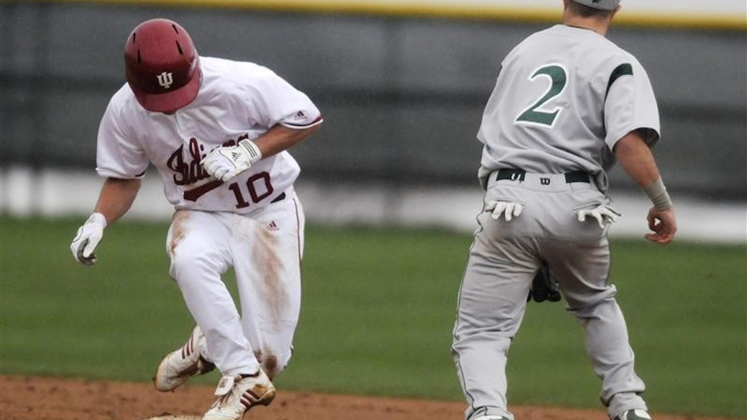 Sophomore outfielder Brian Lambert jumps onto second base after a steal in the rain against Chicago State on Tuesday afternoon at Sembower Field. The Hoosiers face Illinois at 7:05 p.m. Friday on the road.