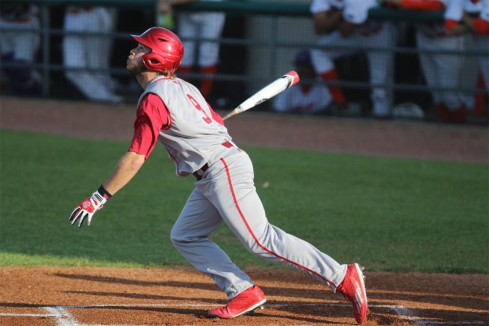 Senior infielder Casey Rodrigue looks to see where the ball will land after hitting it into the outfield. Rodrigue started the game with a double, but the Hoosiers would not score any runs until the third inning.