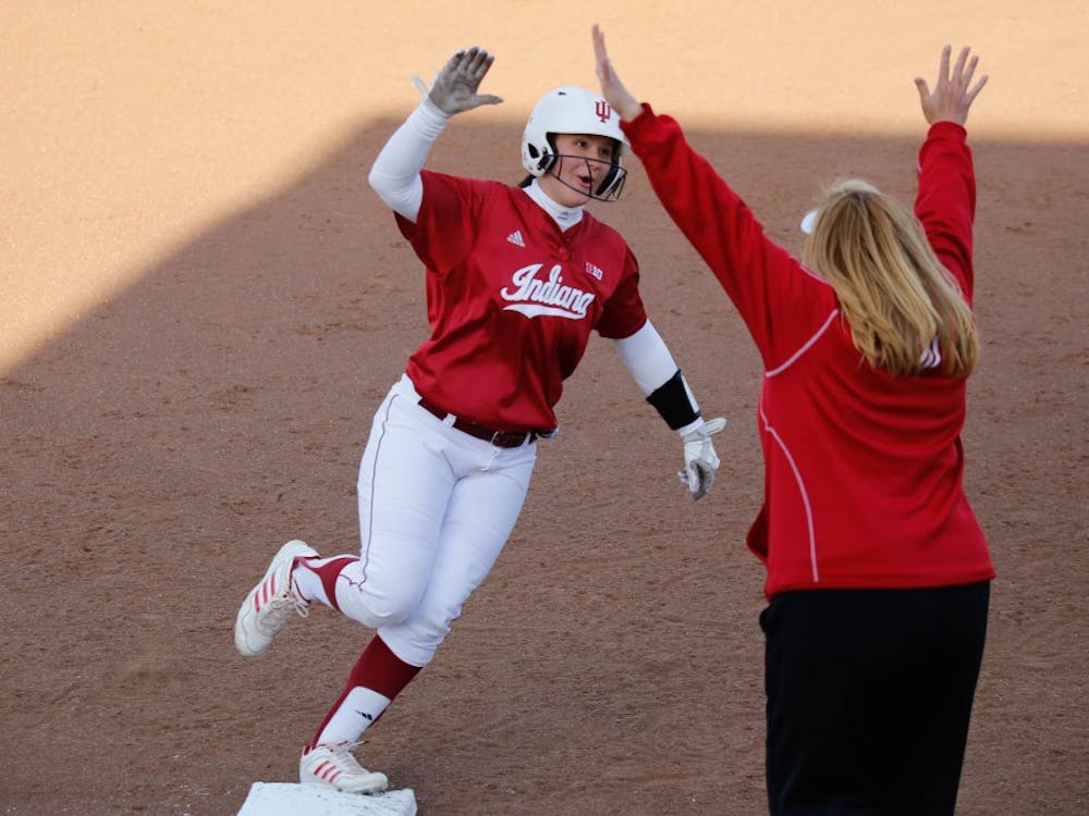Junior Michelle Huber high-fives her coach, Michelle Gardner, after hitting a home run during IU's first game against Purdue on April 22, 2015 at Andy Mohr Field. Gardner, who resigned as head softball coach in May, was replaced by Shonda Stanton on Saturday.