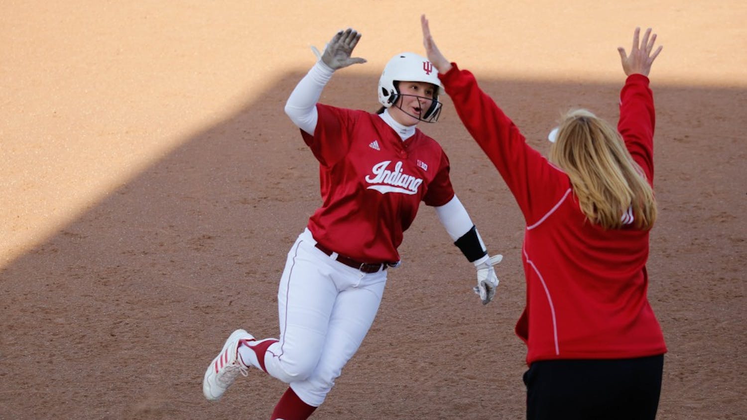 Junior Michelle Huber high-fives her coach, Michelle Gardner, after hitting a home run during IU's first game against Purdue on April 22, 2015 at Andy Mohr Field. Gardner, who resigned as head softball coach in May, was replaced by Shonda Stanton on Saturday.
