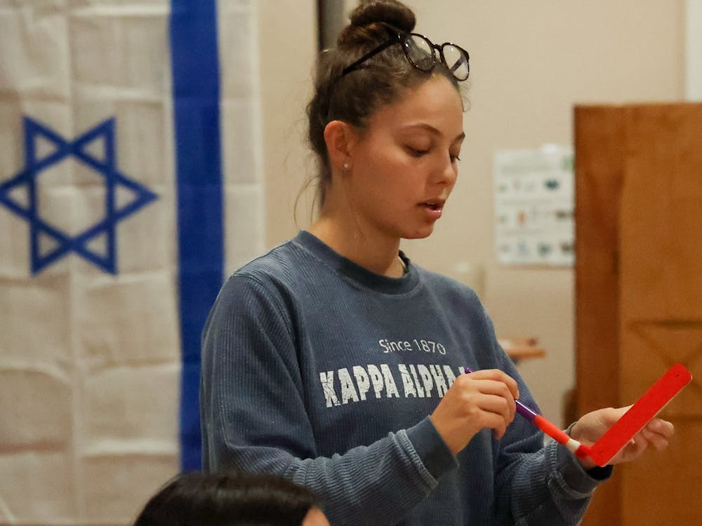 Kaylee Werner, a co-chair of the antisemitism task force at Indiana University Hillel, leads the task force meeting on Oct. 11. The task force meeting was led while painting mezuzahs red to pass out to students.
