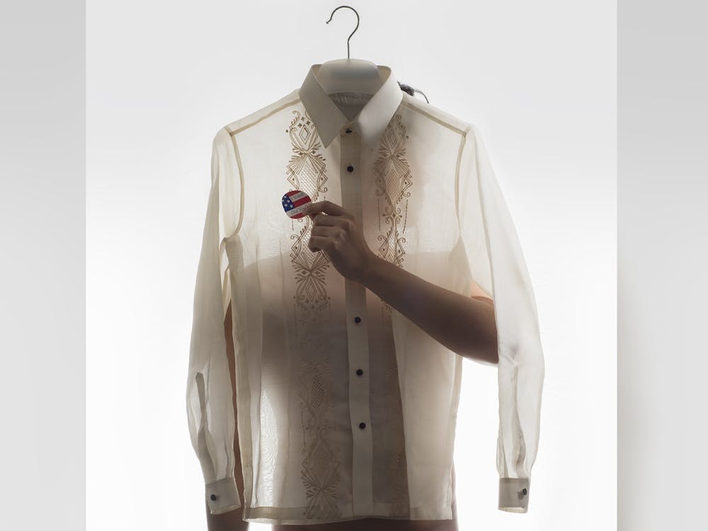A Fillipino shirt and an &quot;I voted&quot; sticker comprise an art piece by Kelvin Burzon, in which he explores the intersectionality of his Filipino and American identities. Works by Burzon and other artists will be on display at the Eskenazi School of Art, Architecture and Design&#x27;s Grunwald Gallery of Art, in the &quot;Identity: Identify&quot; exhibit. 