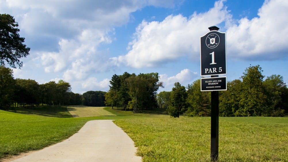 A path runs by the sign for the first hole at the Pfau IU Golf Course. The IU men&#x27;s golf team had its best tournament of the season, finishing fifth out of 12 teams at the Marquette Invitational in Erin Hills, Wisconsin.