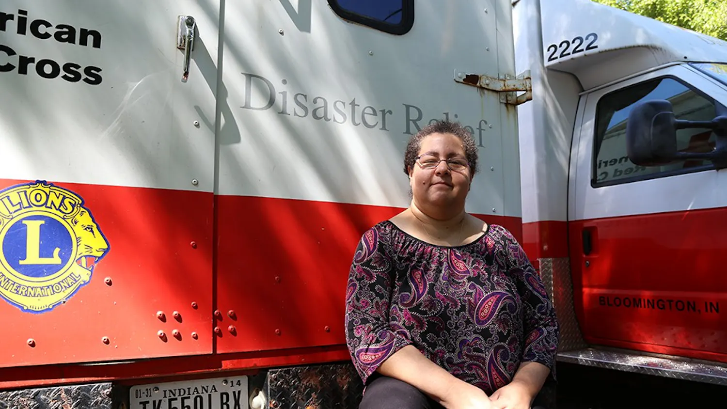 Maria Carrasquillo sits on the bumper of an emergency response vehicle that was used to assist responders at Ground Zero in New York in the days following Sept. 11.
