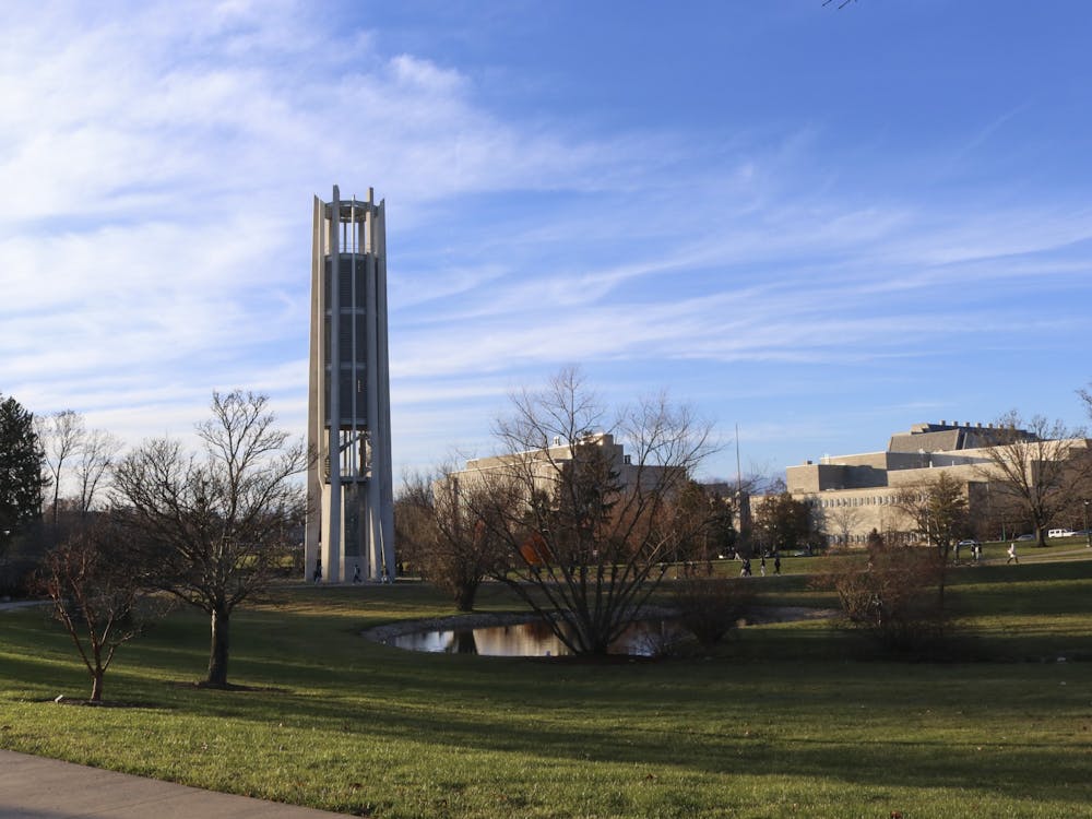 Students walk to past the Arthur R. Metz Bicentennial Grand Carillon on Dec. 6, 2021, in the arboretum. Student environmental groups are calling for IU to make a commitment to climate action based on a resolution written by IUSG last year.