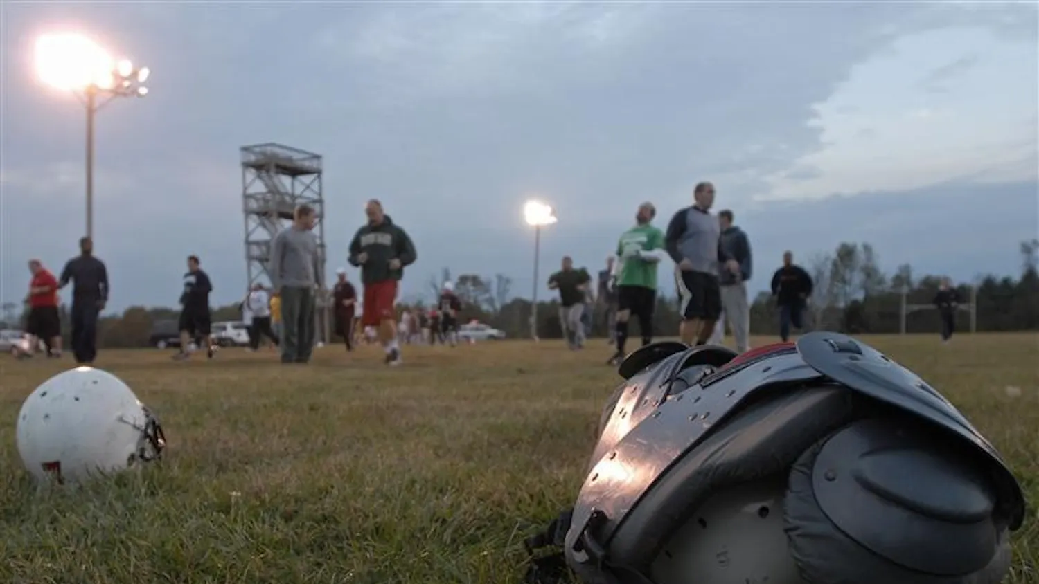 Members of the Cutters football team warm up at the beginning of practice Thursday night at Brown Elementary School in Bloomington. The Cutters are a semi-professional football team with several former IU players competing in the Interstate Football League, a league with teams from Indiana and Ohio.