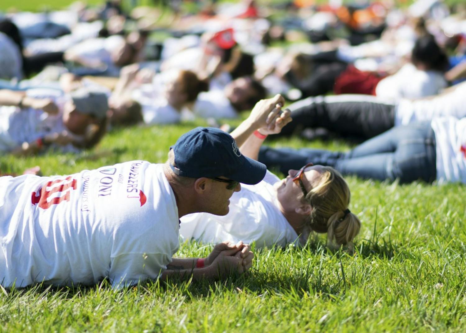 IU employees Herb Jones and April Purlee roll on the ground as part of the Office of Insurance, Loss Control &amp; Claims' organized attempt to break the current world record of 1,719 people simultaneously stop, drop and rolling. The Guinness World Records requires participants roll on the ground for 30 seconds in order for the attempt to count.&nbsp;