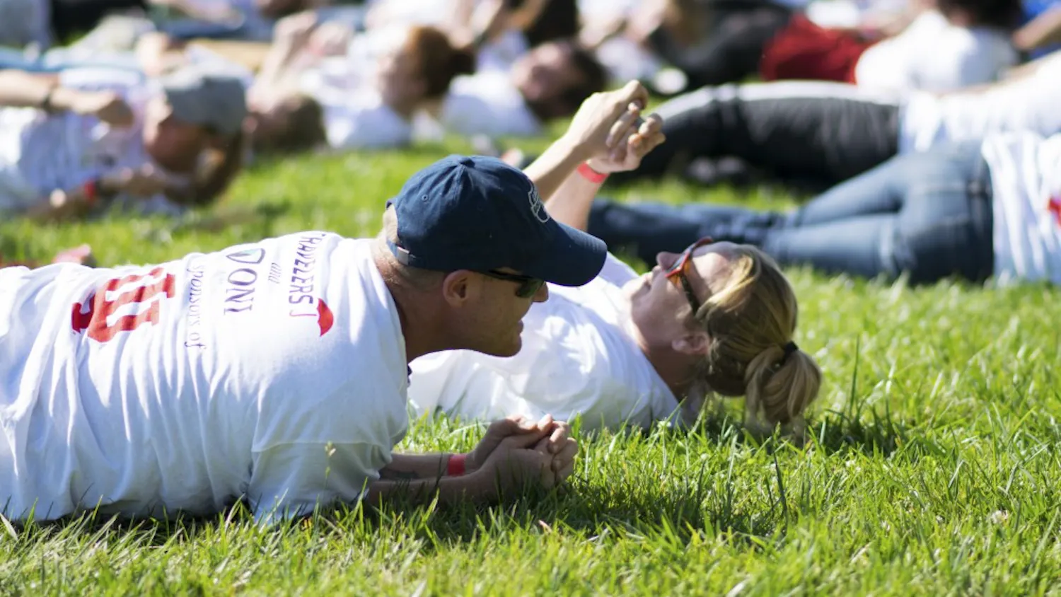 IU employees Herb Jones and April Purlee roll on the ground as part of the Office of Insurance, Loss Control & Claims' organized attempt to break the current world record of 1,719 people simultaneously stop, drop and rolling. The Guinness World Records requires participants roll on the ground for 30 seconds in order for the attempt to count. 