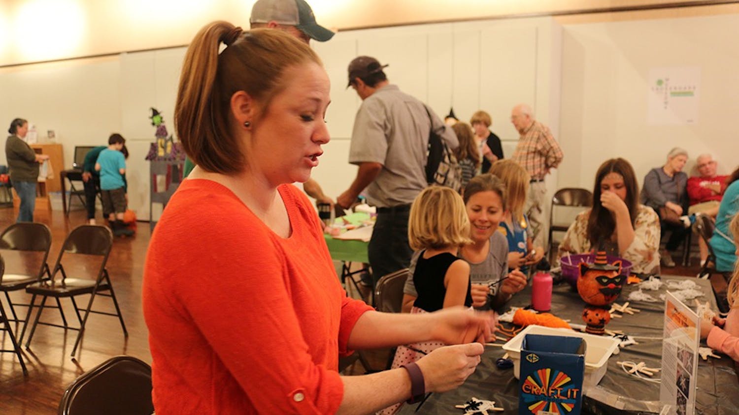Libba Willcox, volunteer for the fest, helps kids make spooky crafts. 