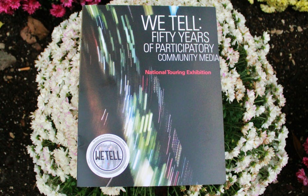 <p>A booklet sits on a flower bed on Oct. 21 in front of the IU Cinema. &quot;We Tell: Body Publics&quot; is part of the traveling national exhibit, &quot;We Tell: Fifty Years of Participatory Community Media,&quot; and showed several short films.</p>