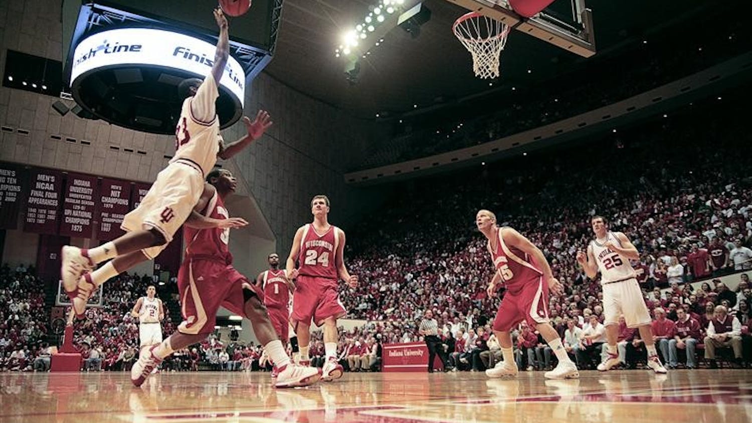 Junior guard Devan Dumes jumps toward the goal during the first half against Wisconsin Thursday evening at Assembly Hall.