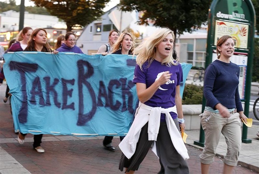 Take Back the Night participants march down Kirkwood Ave. Tuesday night in order to promote awareness of sexual and domestic violence.