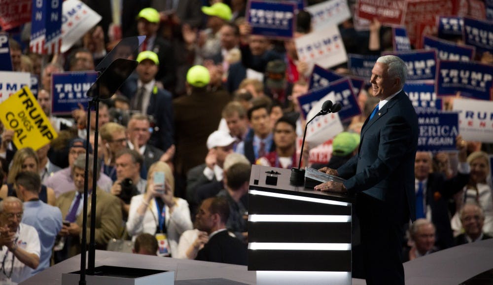 Governor Mike Pence laughs on stage at the Republican National Convention on Wednesday night at the Quicken Loans Arena in Cleveland, Ohio.