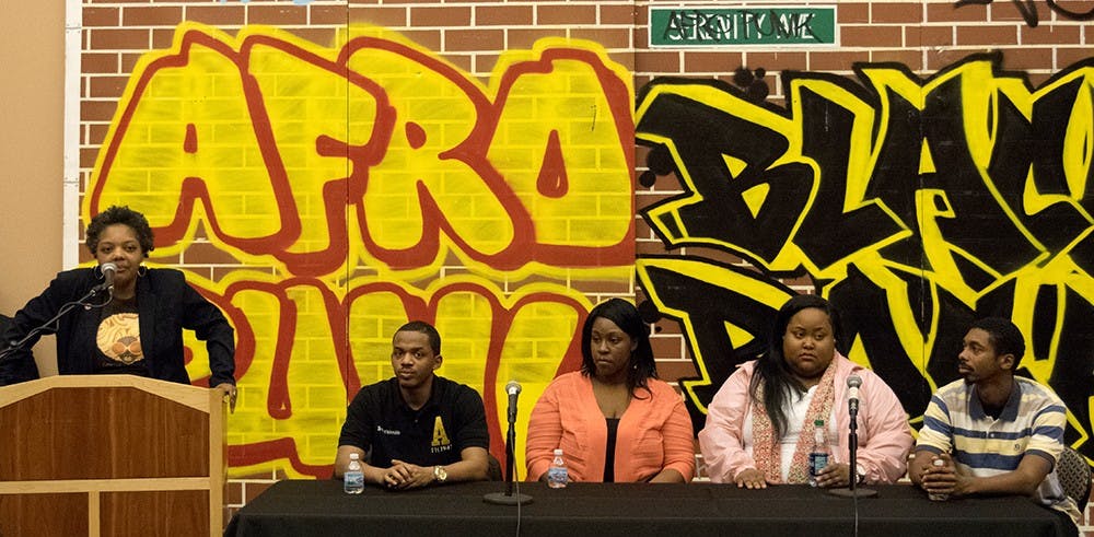Stephanie Power-Carter, left, associate professor at IU School of Education, presents "Breakingdown Racial Barriers" to visiting high school students Monday at Grand Hall in the Neal-Marshall Black Culture Center's Grand. 