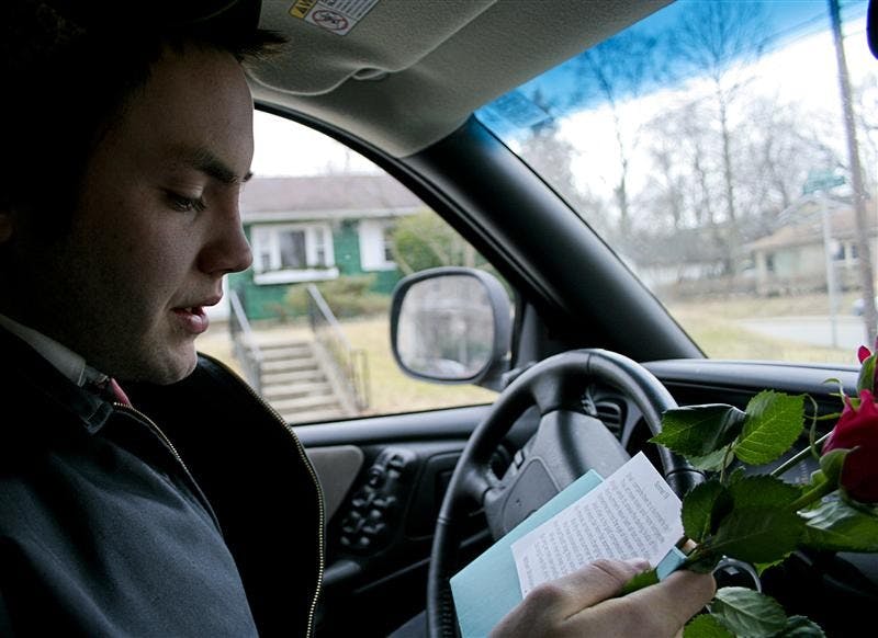 Junior Ian McCabe prepares to read Shakespeare's Sonnet 18 for Irma Cassels, 94, Saturday afternoon outside her house on Wiley Street. McCabe was delivering a Love-You-Gram to Cassels as an actor from the Bloomington Playwrights Project through their Valentine's Day service which is in its fifth year.