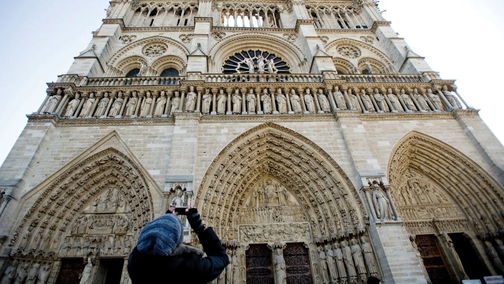 A visitor to the Cathedral Notre Dame in Paris takes a picture.&nbsp;
