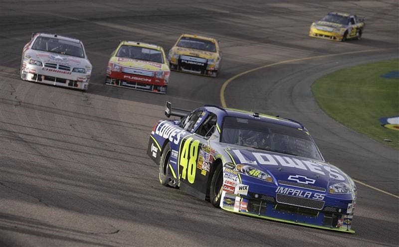 Jimmie Johnson leads a group into turn two during the NASCAR Sprint Cup Series Checker O'Reilly Auto Parts 500 race Sunday at Phoenix International Raceway. Johnson, who is leading by 141 points with one race to go, is widely expected to win his third-straight championship.