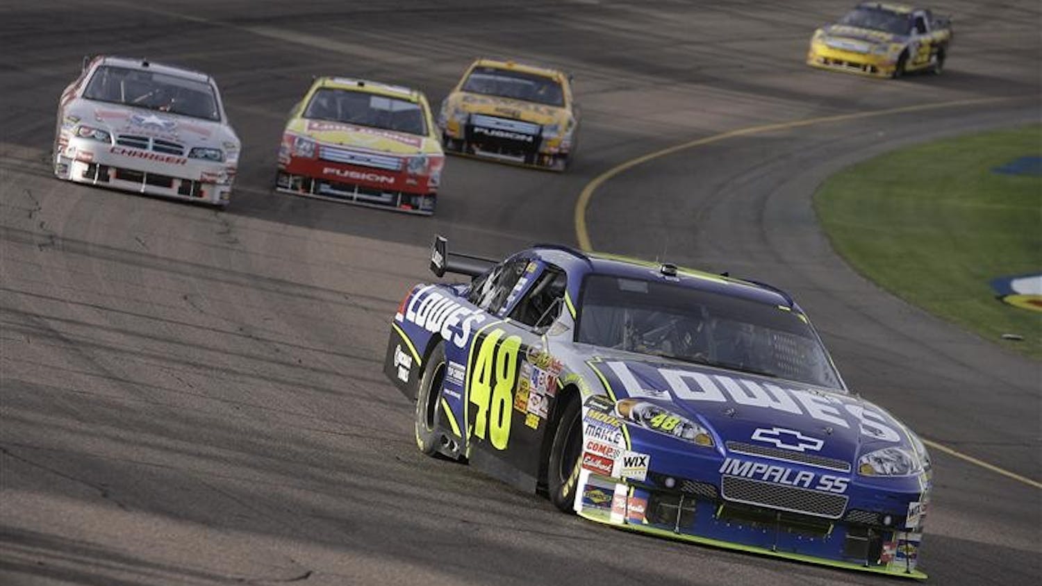Jimmie Johnson leads a group into turn two during the NASCAR Sprint Cup Series Checker O'Reilly Auto Parts 500 race Sunday at Phoenix International Raceway. Johnson, who is leading by 141 points with one race to go, is widely expected to win his third-straight championship.
