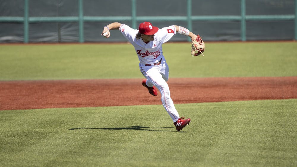 Freshman third baseman Josh Pyne prepares to throw to first base in the first game of a doubleheader against Xavier University on March 20, 2022, at Bart Kaufman Field. Collegiate Baseball Newspaper awarded Pyne, Brock Tibbitts and Carter Mathison with Freshman All-America honors.