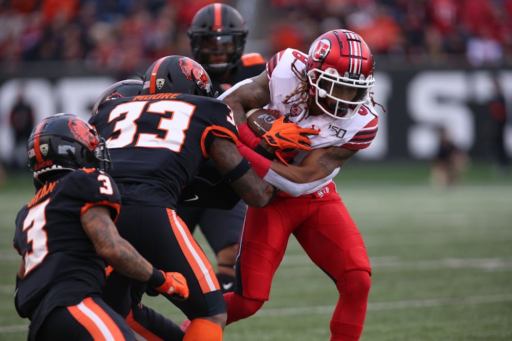 University of Utah wide receiver Derrick Vickers is tackled by an Oregon State University defender Oct. 12 in Corvallis, Oregon. Utah is ranked fifth in the College Football Playoff poll, one spot out of a place in the semifinals.